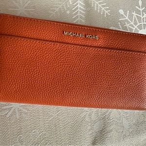 Gently used sturdy soft grained leather wallet with multiple compartments.